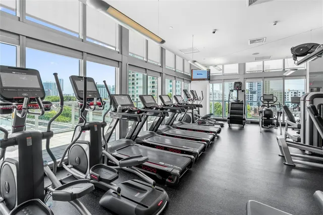 a living room with patio furniture and a large window