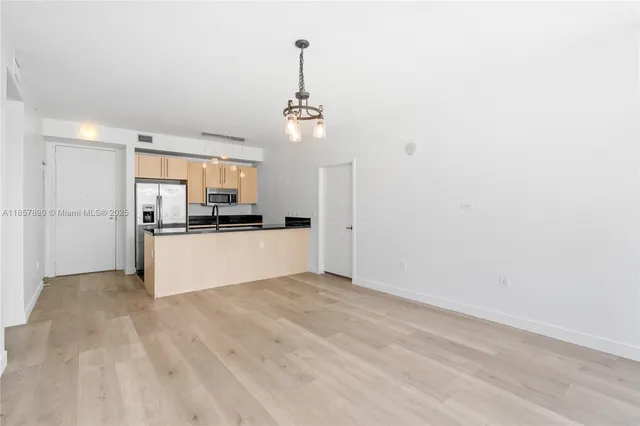 a view of an empty room with windows