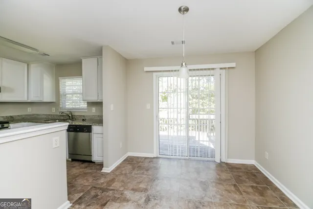 a kitchen with stainless steel appliances granite countertop a stove top oven a sink a counter space and cabinets