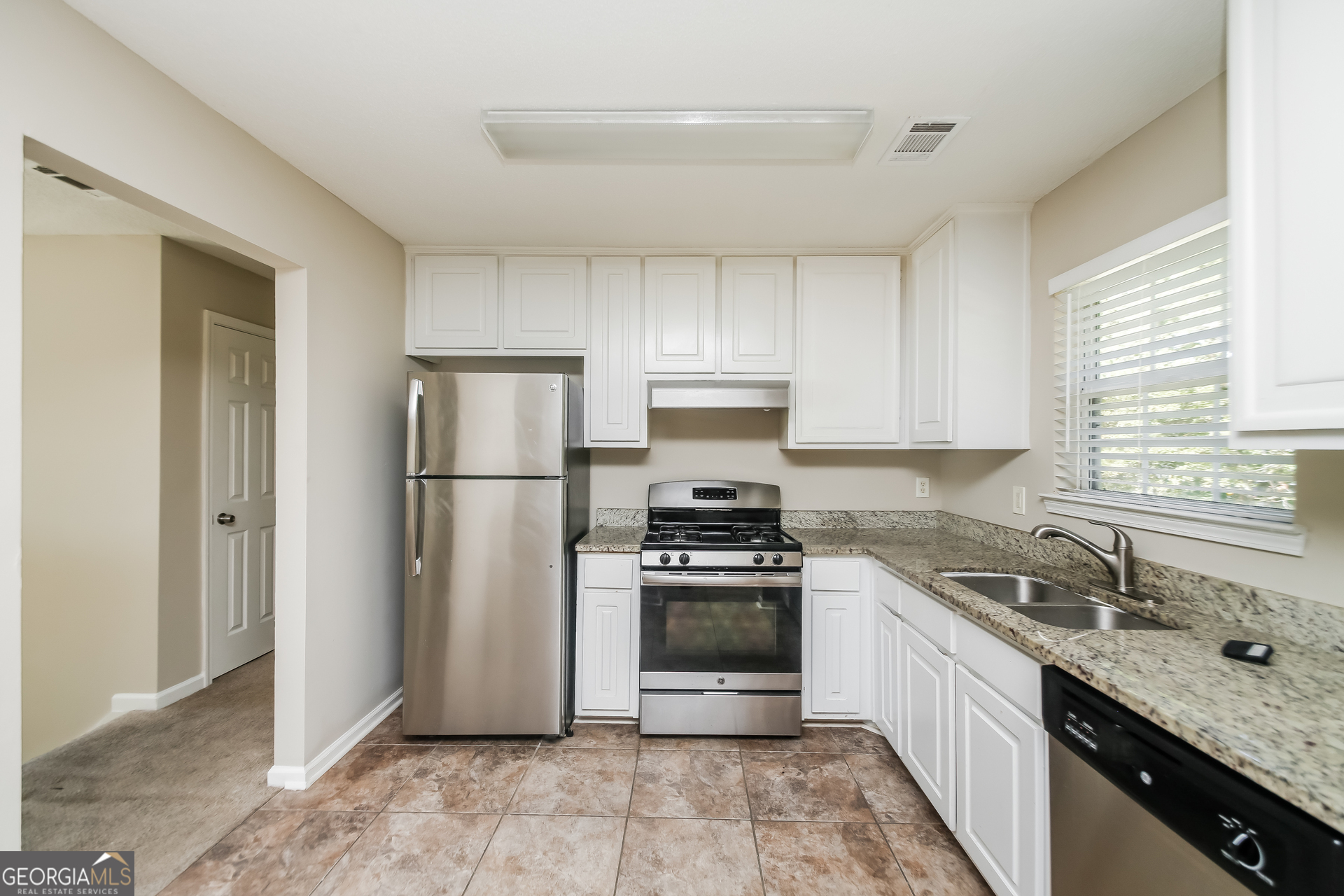 3775 Buffington Place Union City, GA 30291 - Photo 6 of 17 a kitchen with a sink stove and refrigerator