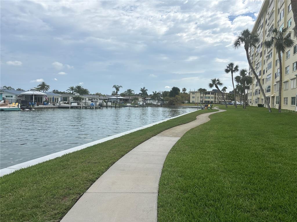 4725 Cove Circle, Unit 405 St. Petersburg, FL 33708 - Photo 22 of 23 a view of a lake with houses in the back