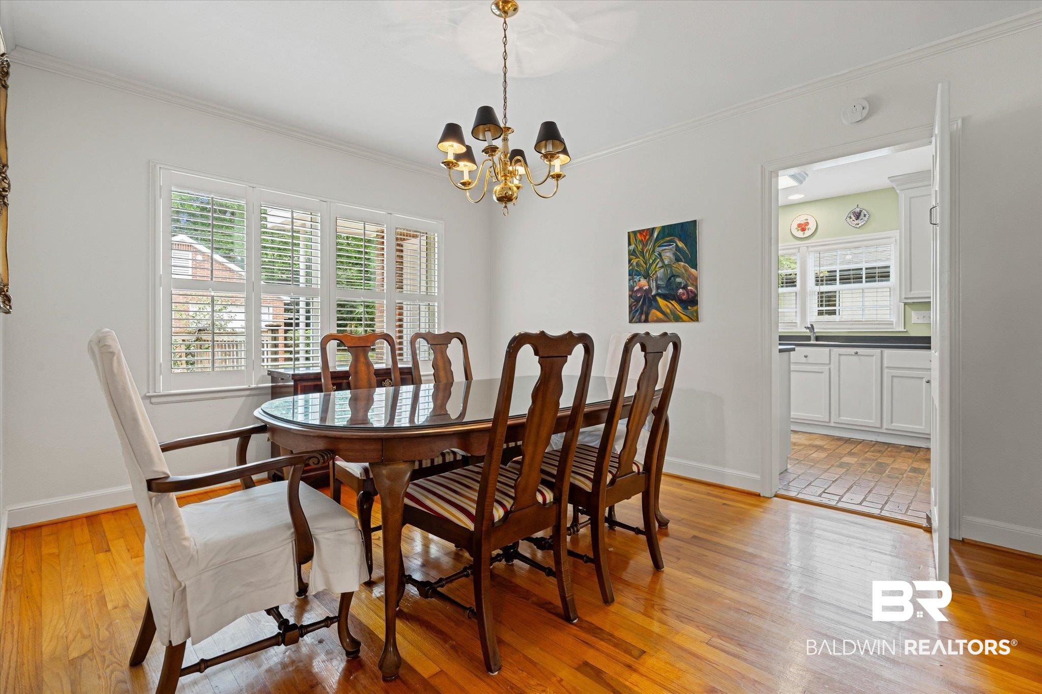 300 Woodlands Avenue Mobile, AL 36607 - Photo 6 of 23 Dining area featuring light wood-type flooring, ornamental molding, and a chandelier