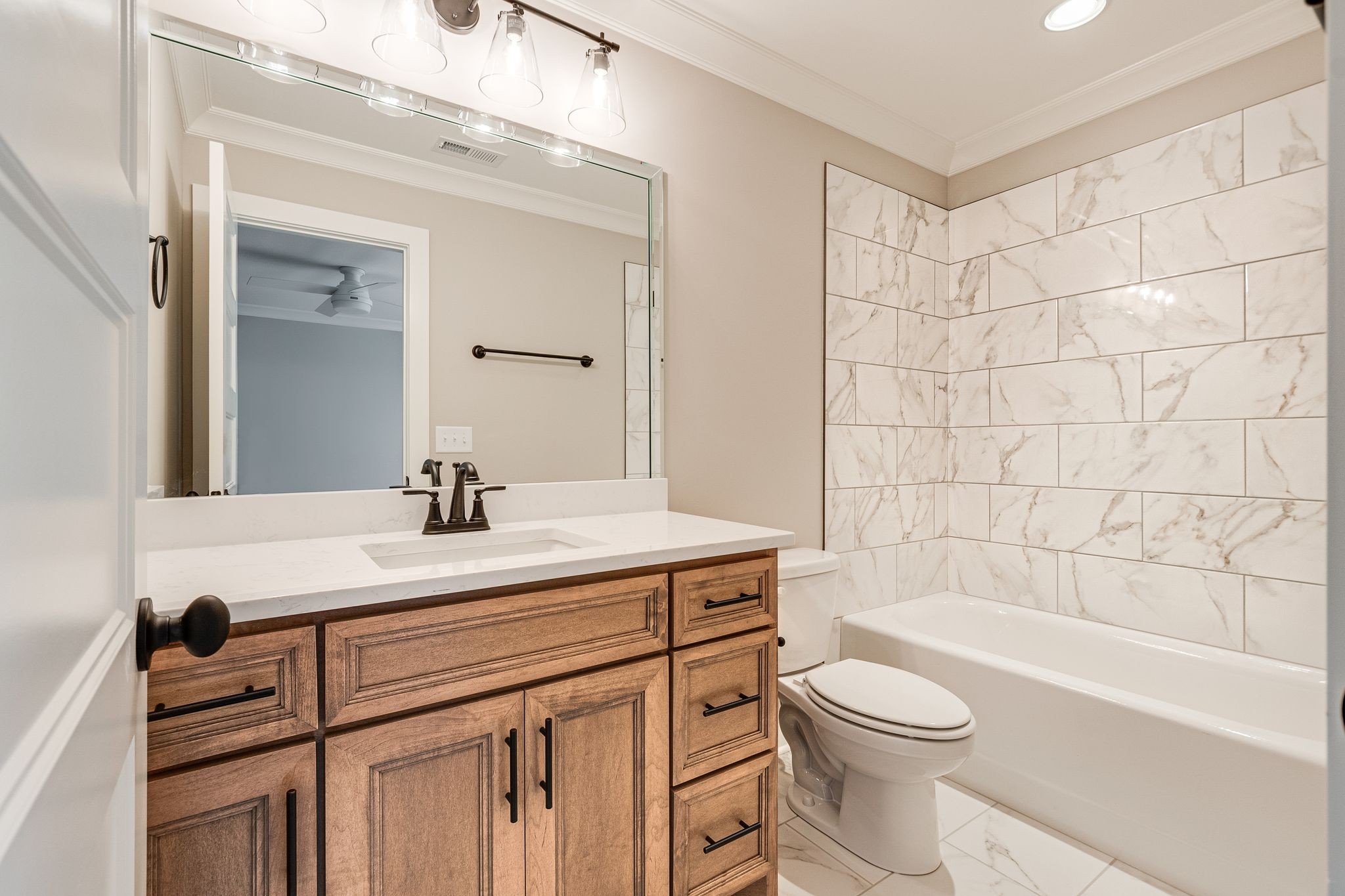1635 Phillips Road Lebanon, TN 37087 - Photo 34 of 40 a bathroom with a sink a toilet a mirror and bathtub