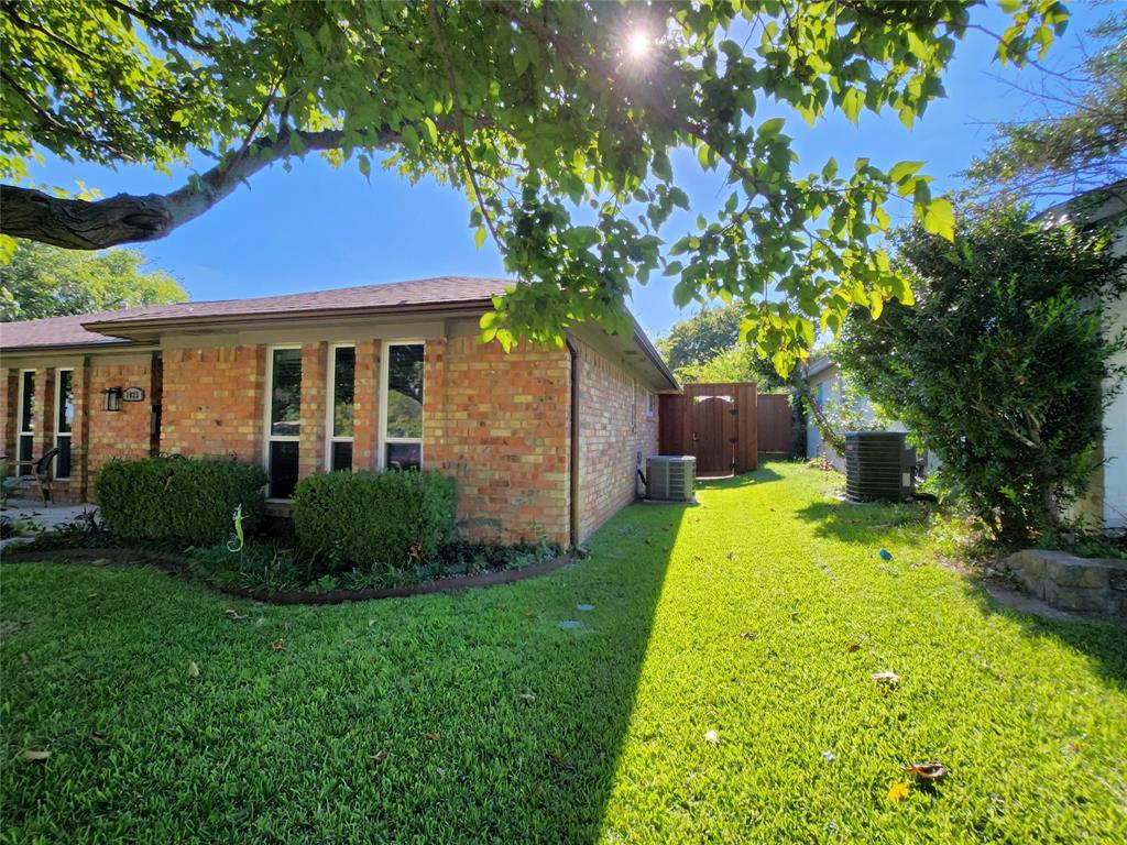 1023 Ridgefield Drive Plano, TX 75075 - Photo 2 of 39 a front view of a house with garden