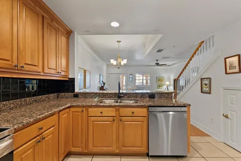 a kitchen with granite countertop cabinets and window