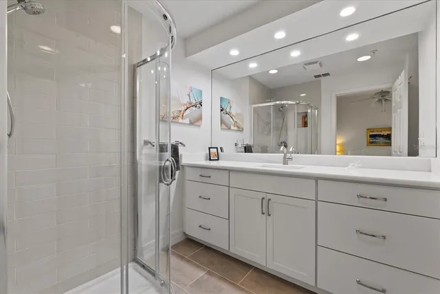 a bathroom with a double vanity sink mirror and shower