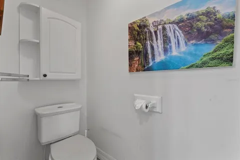 a white toilet sitting next to a bathroom sink