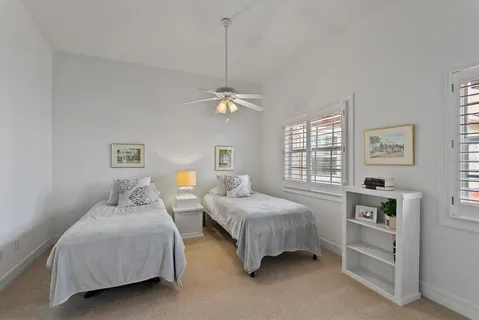 a bedroom with two beds and a window