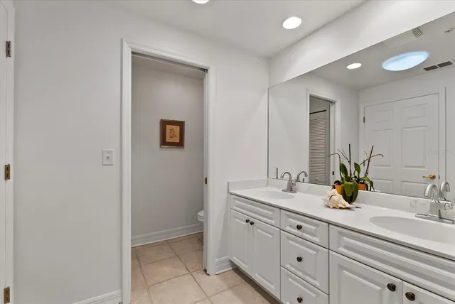 a bathroom with a double vanity sink and a mirror