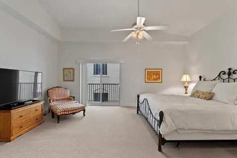 a bedroom with a bed and a chair