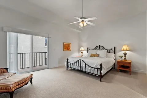 a spacious bedroom with a bed and a window