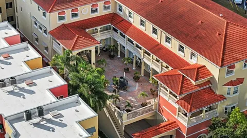 a aerial view of a house with pool and sitting area