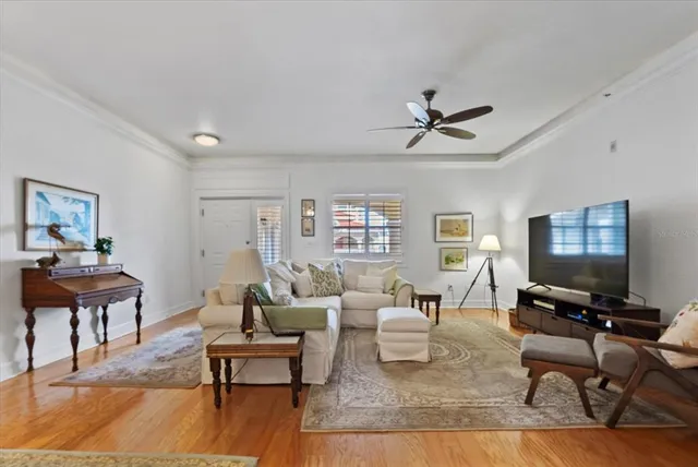 a living room with furniture a rug and a flat screen tv