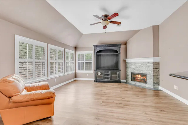 a living room with furniture a fireplace and a flat screen tv