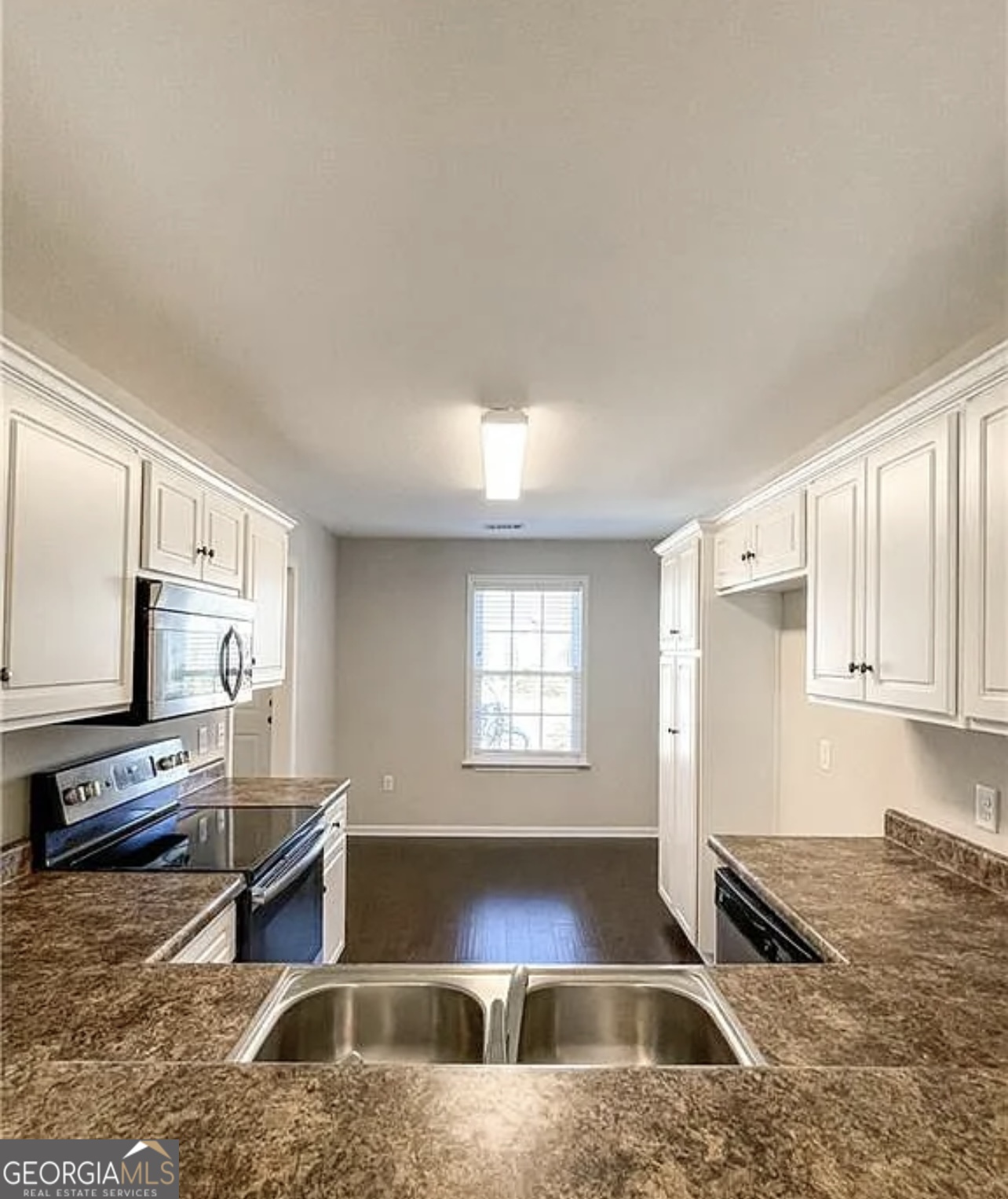 143 Buckhaven Way Statesboro, GA 30458 - Photo 2 of 14 a kitchen with granite countertop a stove a sink and a microwave