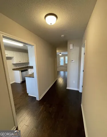 a view of a kitchen with wooden floor and a sink