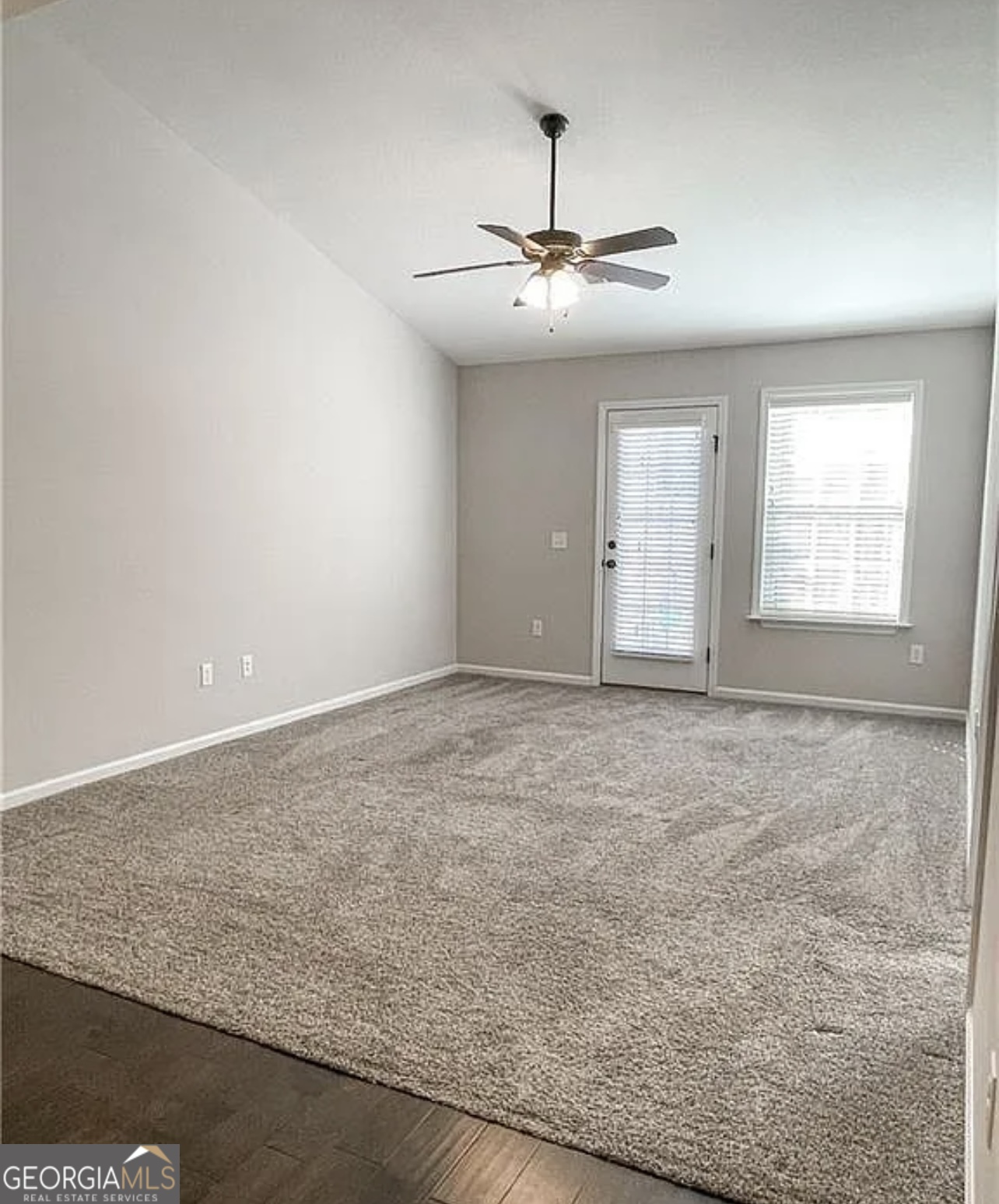 143 Buckhaven Way Statesboro, GA 30458 - Photo 6 of 14 an empty room with chandelier fan and windows