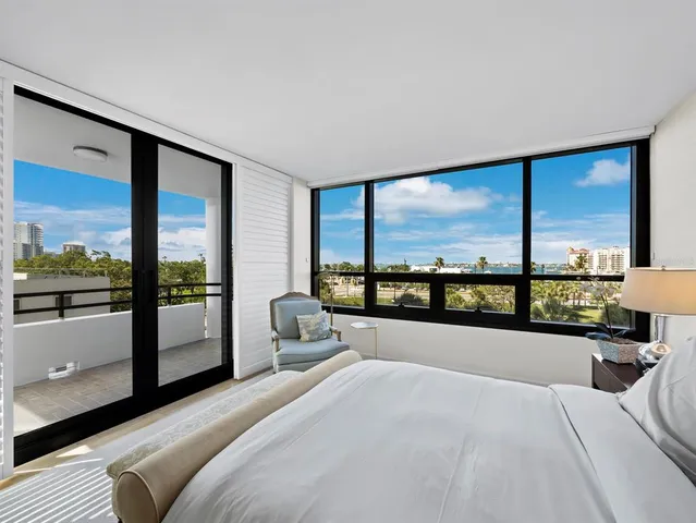 a bedroom with a large bed and a large window