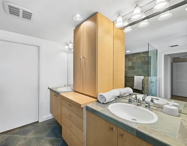 a bathroom with a double vanity sink and mirror