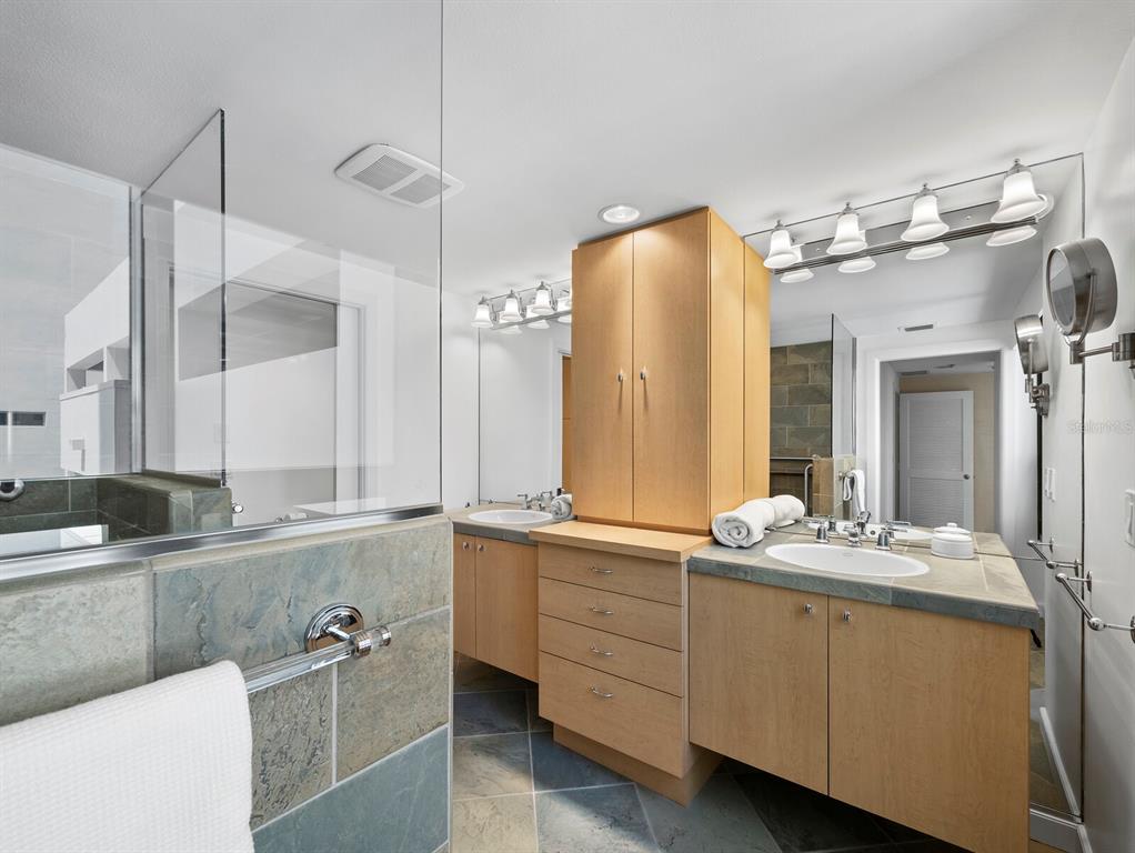1255 North Gulfstream Avenue, Unit 408 Sarasota, FL 34236 - Photo 19 of 35 a bathroom with a double vanity sink mirror and double