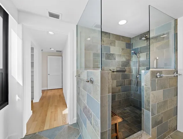 a bathroom with a glass shower door and a sink