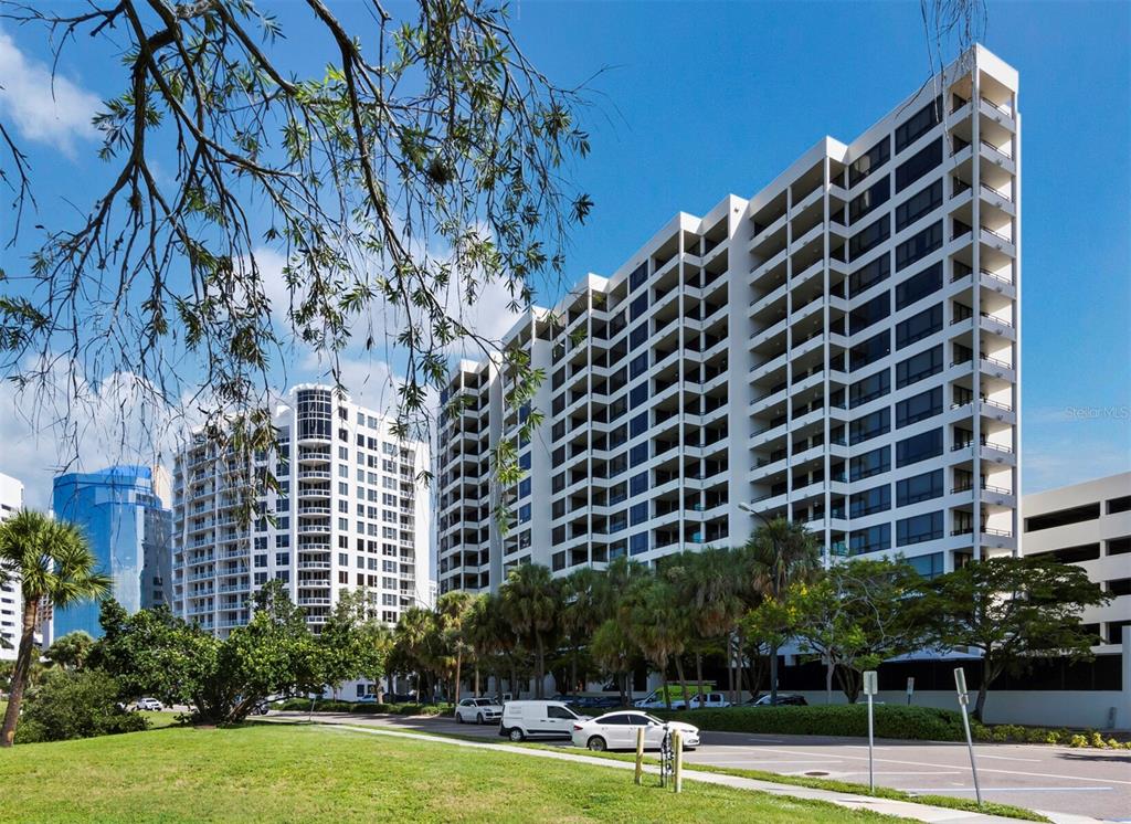 1255 North Gulfstream Avenue, Unit 408 Sarasota, FL 34236 - Photo 2 of 35 a view of a building with garden and trees