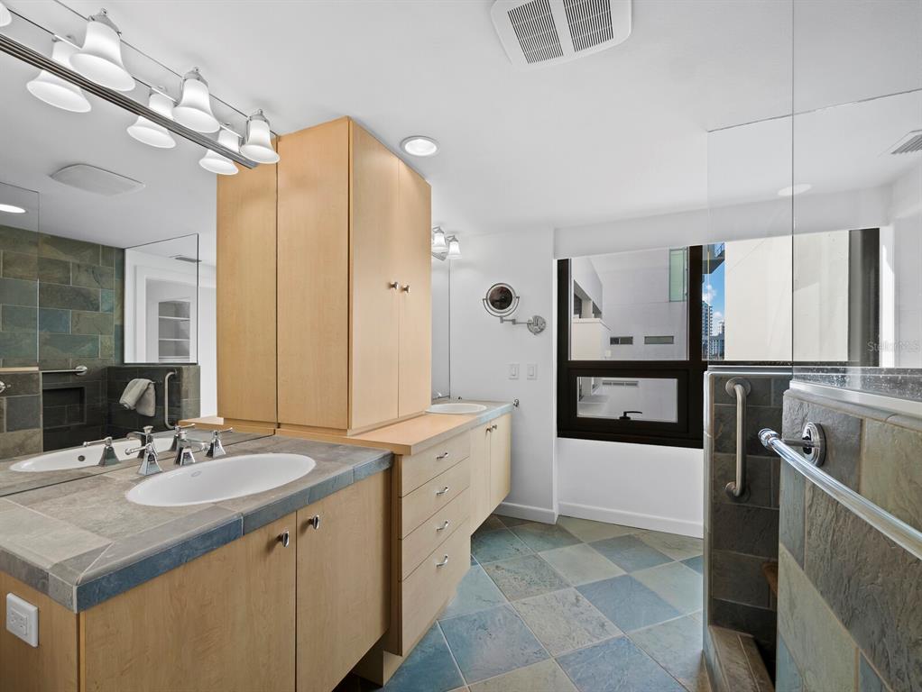1255 North Gulfstream Avenue, Unit 408 Sarasota, FL 34236 - Photo 21 of 35 a spacious bathroom with a sink double vanity granite and a mirror