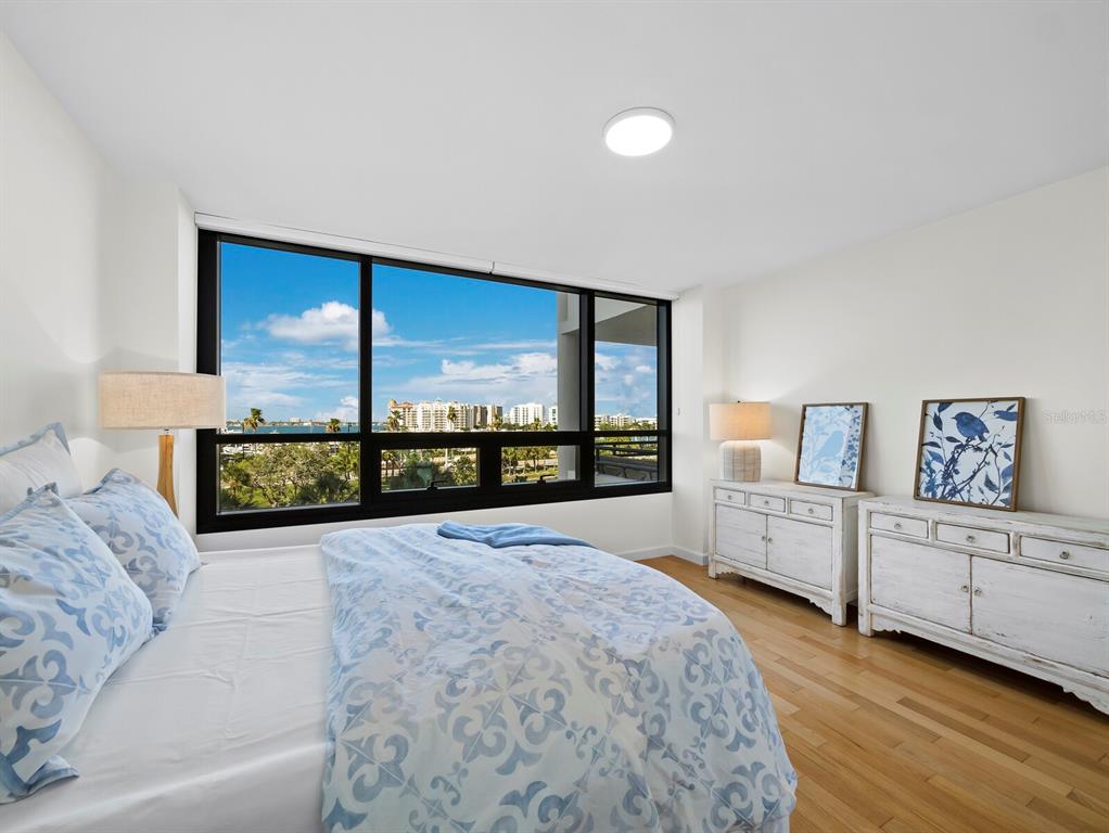 1255 North Gulfstream Avenue, Unit 408 Sarasota, FL 34236 - Photo 23 of 35 a large bedroom with a large bed and a large window