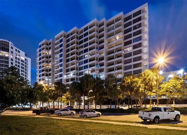 a view of swimming pool with outdoor seating and covered with trees