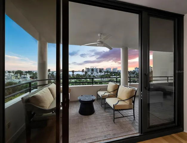 a city view from a balcony with furniture