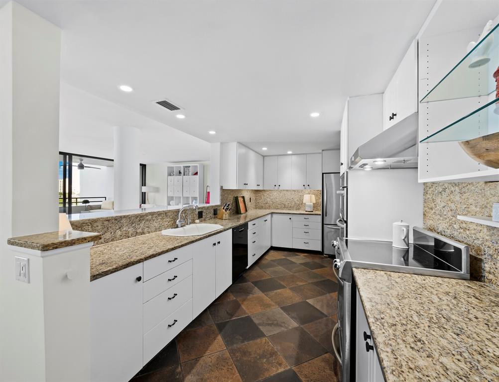 1255 North Gulfstream Avenue, Unit 408 Sarasota, FL 34236 - Photo 10 of 35 a large white kitchen with a stove and a sink