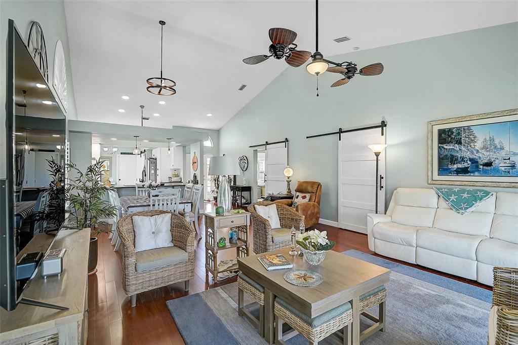 4934 Clubview Court East Bradenton, FL 34203 - Photo 11 of 44 a living room with furniture kitchen view and a chandelier