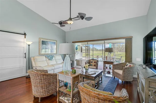 a living room with furniture and a floor to ceiling window