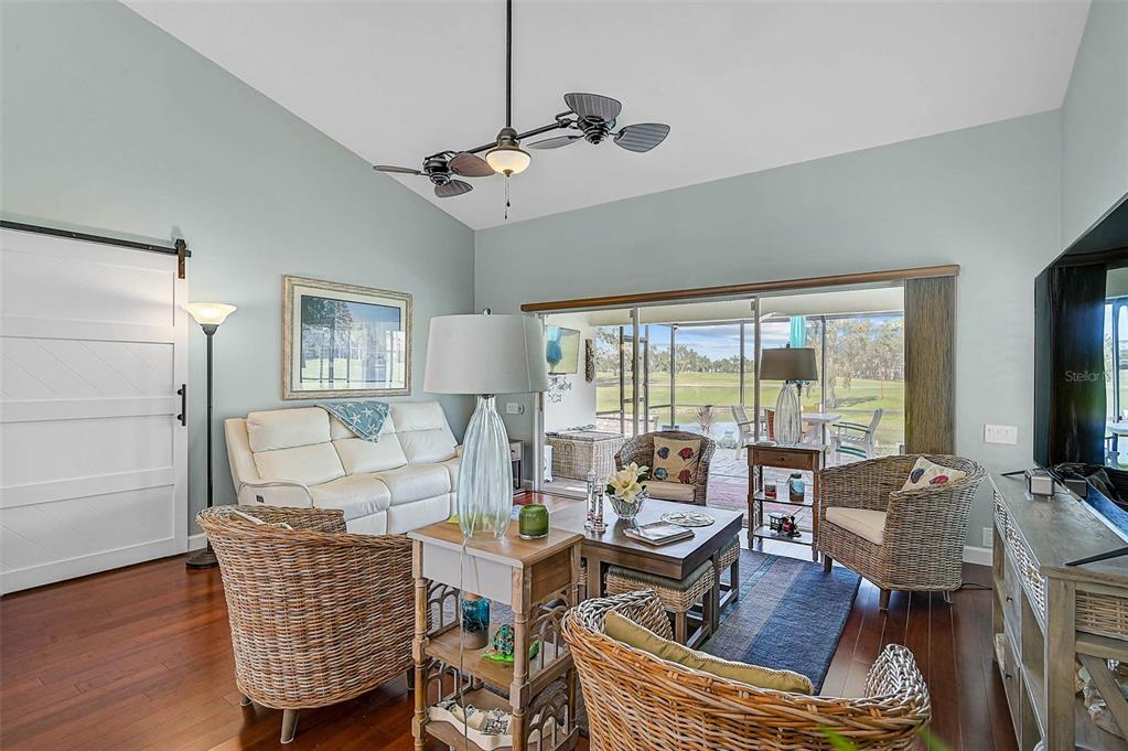 4934 Clubview Court East Bradenton, FL 34203 - Photo 12 of 44 a living room with furniture and a floor to ceiling window