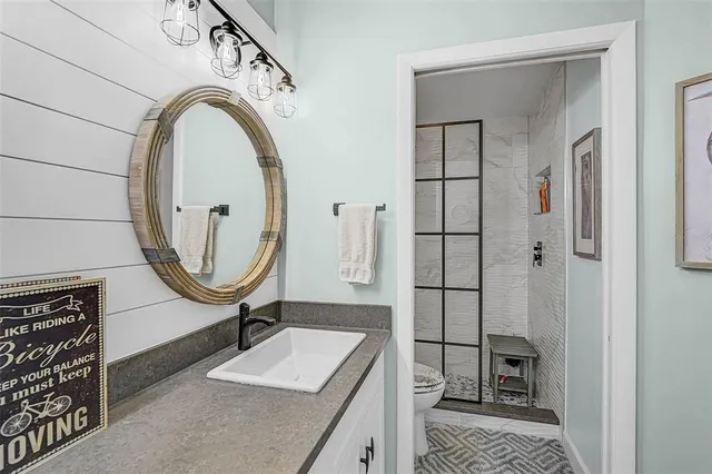 a bathroom with a sink a mirror and a shower