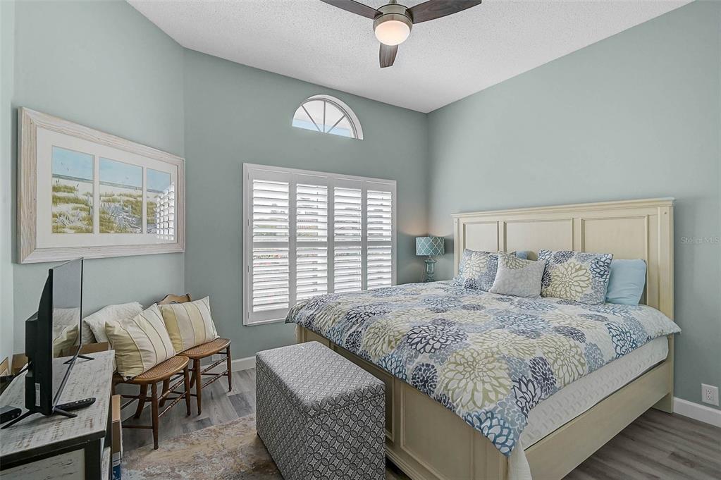 4934 Clubview Court East Bradenton, FL 34203 - Photo 22 of 44 a bedroom with a bed a couch and a window