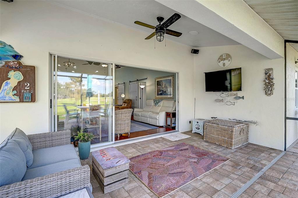 4934 Clubview Court East Bradenton, FL 34203 - Photo 28 of 44 a living room with furniture a flat screen tv and a fireplace