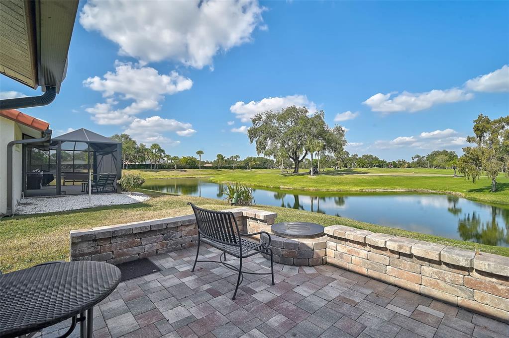 4934 Clubview Court East Bradenton, FL 34203 - Photo 34 of 44 a view of a swimming pool and lounge chairs in back yard of the house