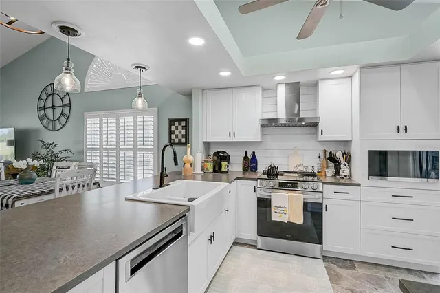 a kitchen with a white cabinets and chandelier