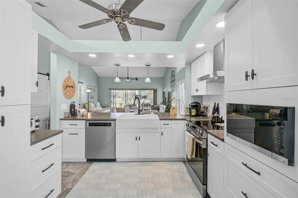 4934 Clubview Court East Bradenton, FL 34203 - Photo 6 of 44 a kitchen with a sink stainless steel appliances and cabinets