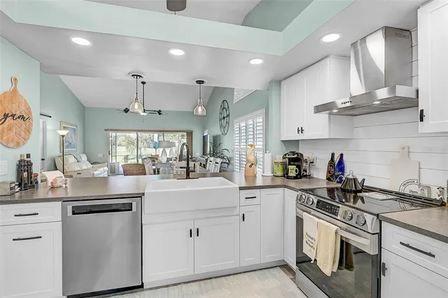 a kitchen with stainless steel appliances white cabinets and a sink