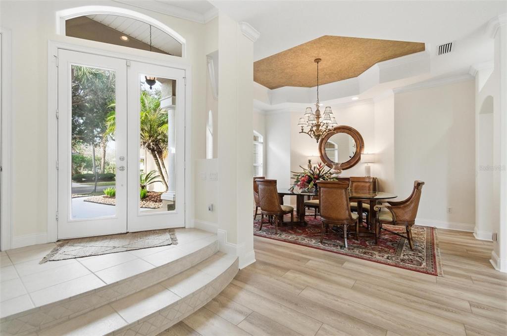 83 Front Street Palm Coast, FL 32137 - Photo 11 of 100 a view of a dining room and hall with wooden floor
