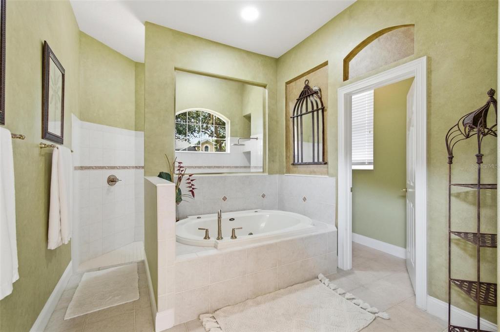 83 Front Street Palm Coast, FL 32137 - Photo 17 of 100 a bathroom with a bathtub and a shower