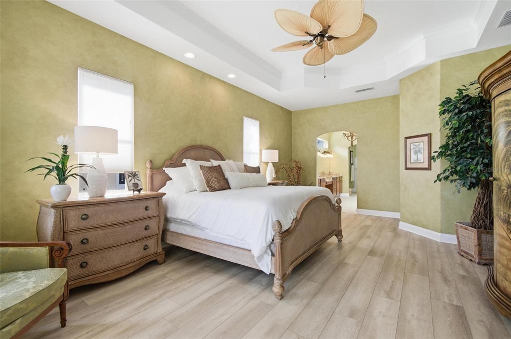 83 Front Street Palm Coast, FL 32137 - Photo 19 of 100 a bedroom with a bed and a chandelier fan