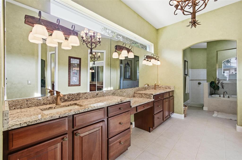 83 Front Street Palm Coast, FL 32137 - Photo 20 of 100 a spacious bathroom with a granite countertop double vanity sink and a mirror