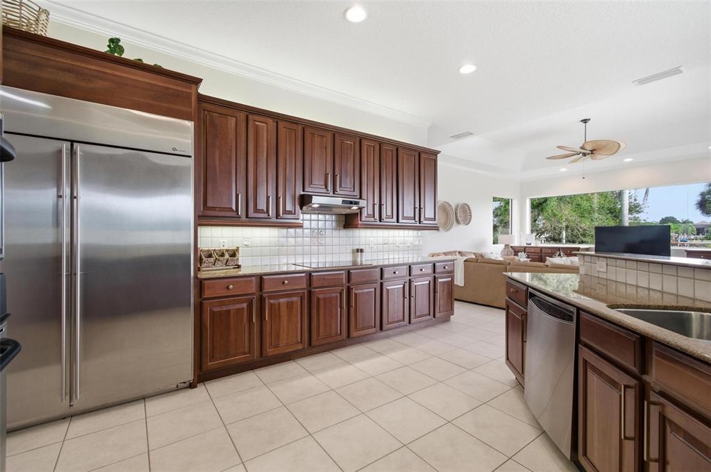 83 Front Street Palm Coast, FL 32137 - Photo 27 of 100 a kitchen with stainless steel appliances granite countertop a sink counter space cabinets and a large window