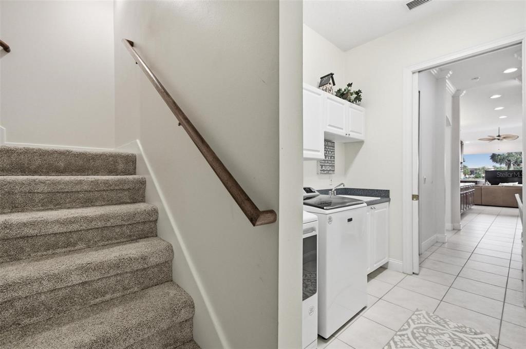 83 Front Street Palm Coast, FL 32137 - Photo 37 of 100 a view of a hallway with wooden floor and staircase