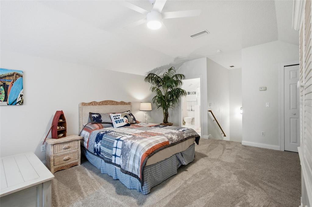 83 Front Street Palm Coast, FL 32137 - Photo 39 of 100 a bedroom with a bed and a potted plant