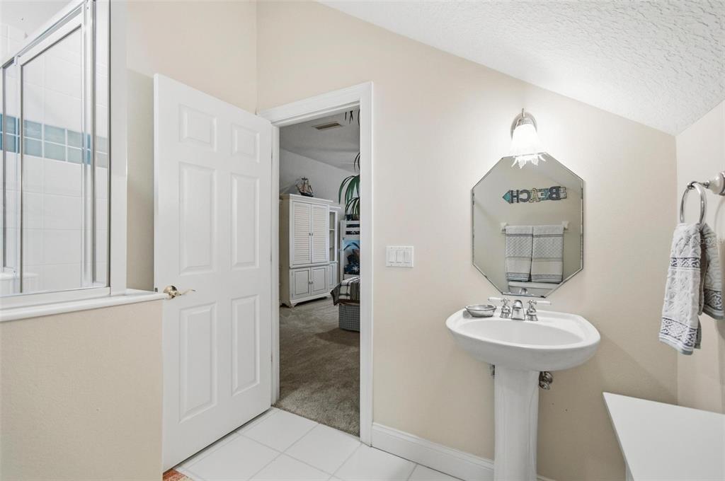 83 Front Street Palm Coast, FL 32137 - Photo 41 of 100 a bathroom with a sink a mirror and a shower