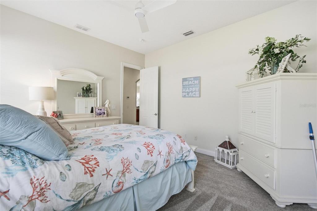 83 Front Street Palm Coast, FL 32137 - Photo 45 of 100 a bedroom with a bed and a potted plant